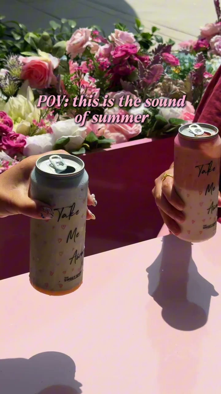 Iced Sweet Spot coffee cans in a bright pink summer setting