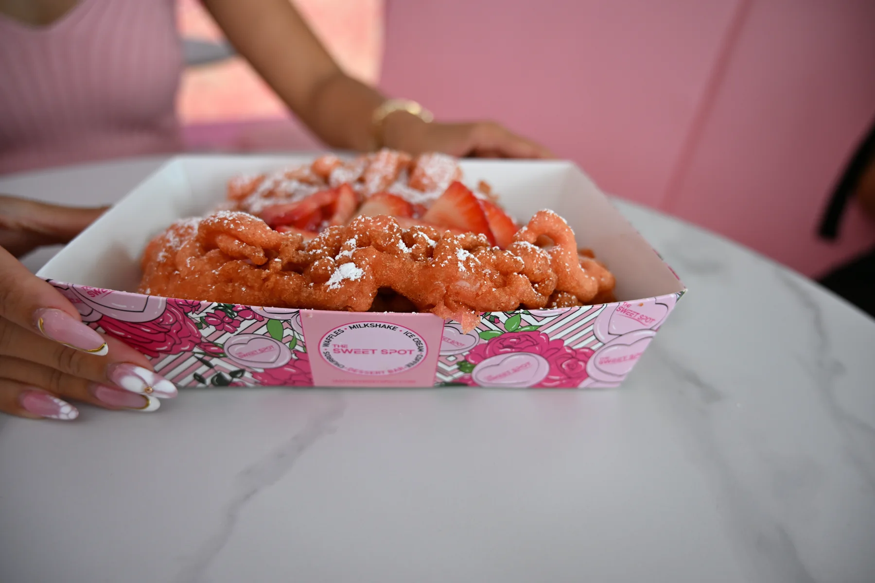 Strawberry funnel cake with powdered sugar from The Sweet Spot in Virginia Beach