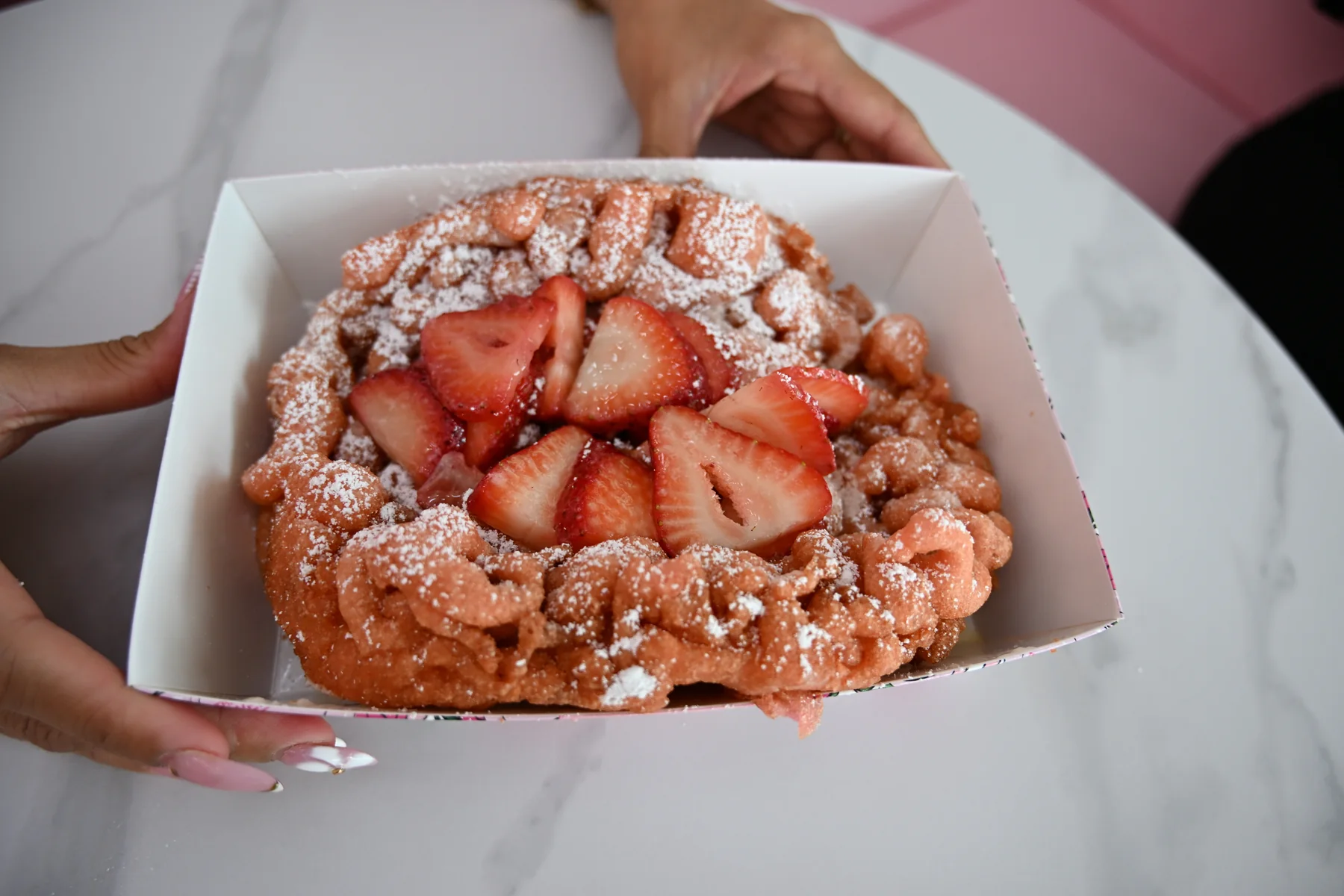 Strawberry funnel cake with powdered sugar from The Sweet Spot in Virginia Beach