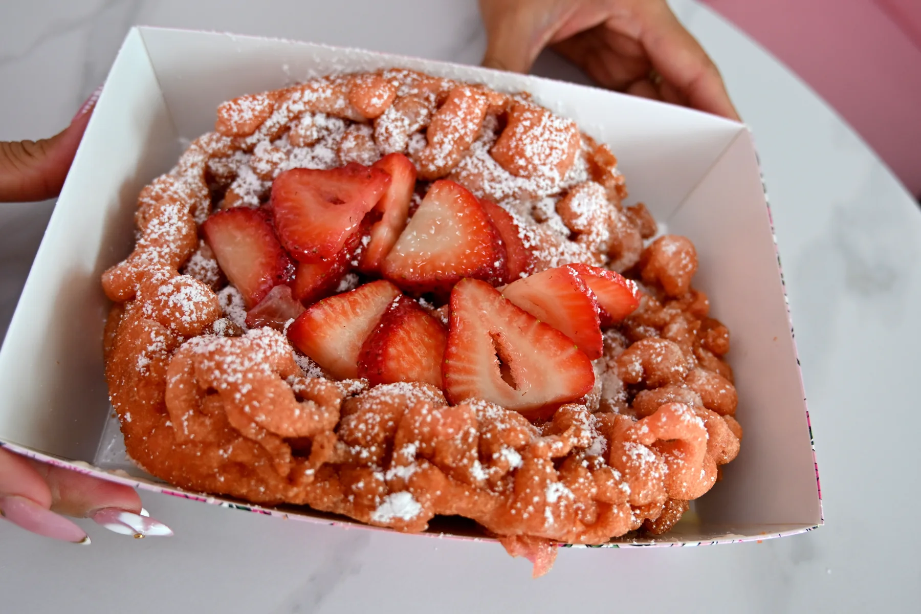 Strawberry funnel cake with powdered sugar from The Sweet Spot in Virginia Beach